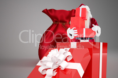 Composite image of santa standing in large gift