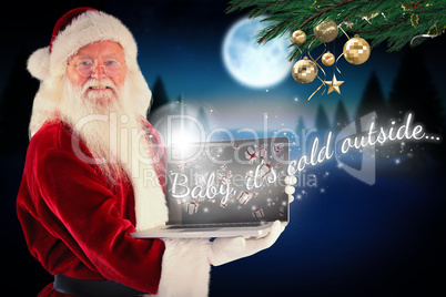 Composite image of santa claus presents a laptop