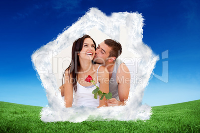 Composite image of lovers sitting on bed with a rose