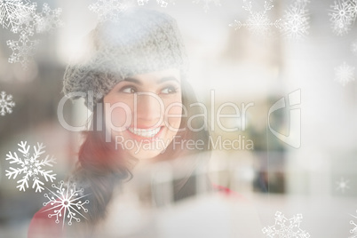 Composite image of portrait of a smiling brunette in grey hat