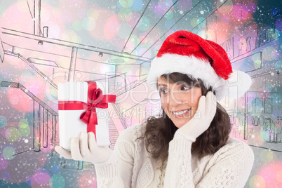 Composite image of pretty santa girl holding gift