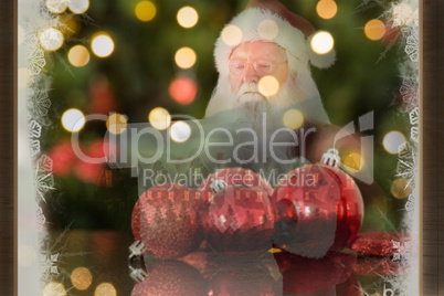 Composite image of santa claus reads a list