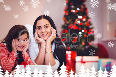 Composite image of festive mother and daughter smiling at camera