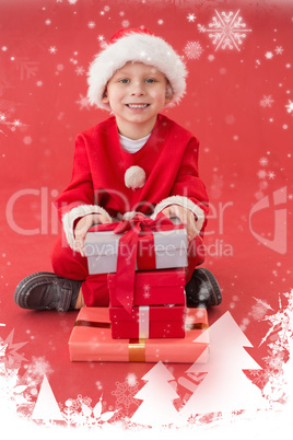 Composite image of cute little boy in santa costume with gifts