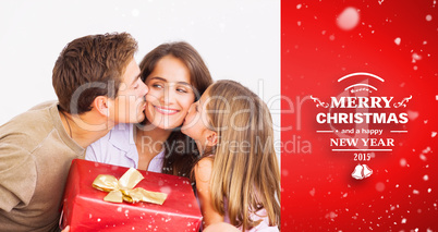 Composite image of father and his daughter offering a red gift