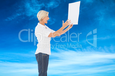 Composite image of angry woman shouting at piece of paper