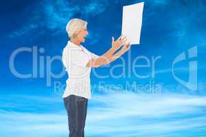 Composite image of angry woman shouting at piece of paper