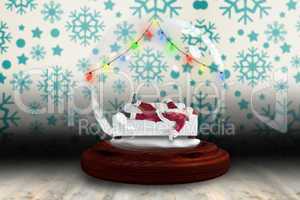 Santa sleeping in snow globe