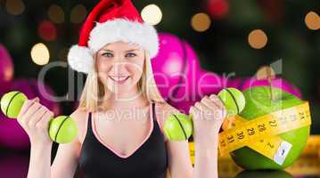 Composite image of festive fit blonde smiling at camera