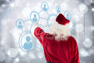 Composite image of santa claus points at something