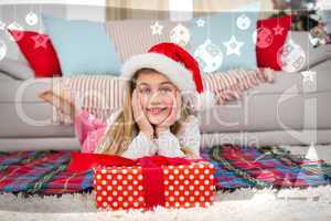 Composite image of festive little girl smiling at camera with gi
