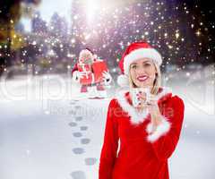 Composite image of festive blonde holding a mug