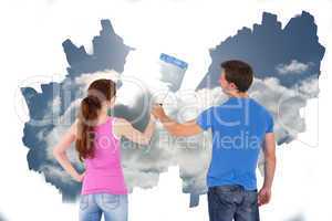 Composite image of couple painting together