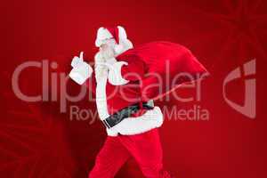 Composite image of positive santa with a sack and thumbs up