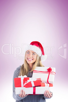 Festive blonde holding pile of gifts