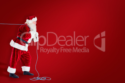 Composite image of santa claus pulling rope