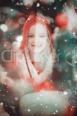 Composite image of festive little girl in hat and scarf