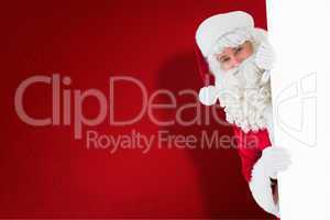 Composite image of happy santa claus holding poster