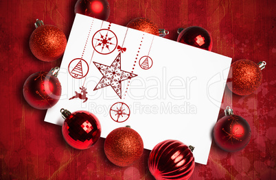 Composite image of hanging red christmas decorations