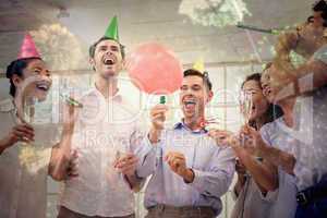 Composite image of casual business team celebrating with champag