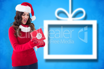 Composite image of disappointed brunette opening christmas gift