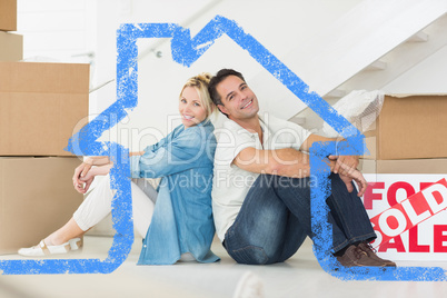 Composite image of smiling couple with boxes in a new house