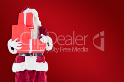 Composite image of santa covers his face with presents