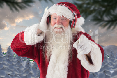 Composite image of santa is listening some music