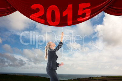 Composite image of businesswoman pulling a chain