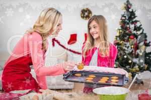 Composite image of festive mother and daughter making christmas