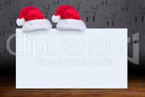 Composite image of santa hat on poster