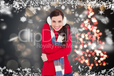 Composite image of happy brunette in winter clothes smiling at c
