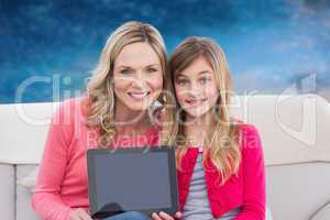 Composite image of mother and daughter with tablet