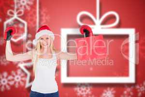 Composite image of festive blonde cheering with boxing gloves