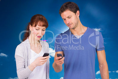 Composite image of couple using their mobile phones