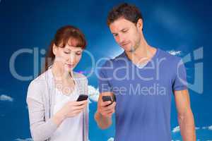 Composite image of couple using their mobile phones