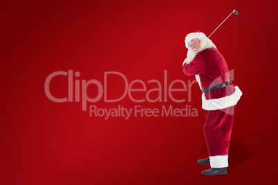 Composite image of santa claus swings his golf club