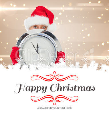 Composite image of festive woman holding clock