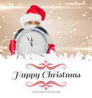 Composite image of festive woman holding clock