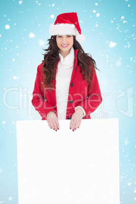 Composite image of cheerful brunette showing white poster