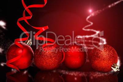 Composite image of four red christmas ball decorations