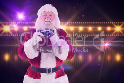 Composite image of santa is taking a picture