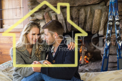 Composite image of romantic couple in front of lit fireplace