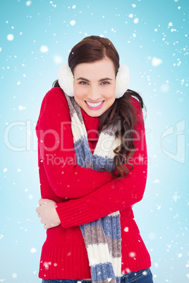 Composite image of happy brunette in winter clothes smiling at c