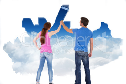 Composite image of couple painting together