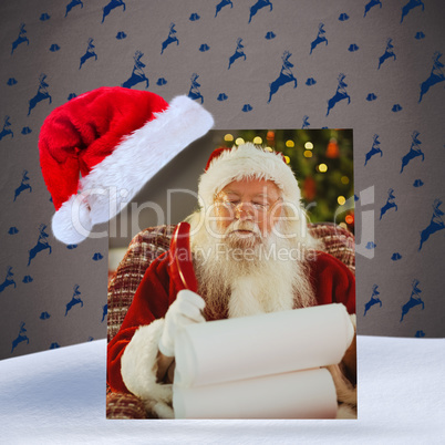 Composite image of santa claus writing his list with a quill
