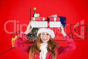 Composite image of festive redhead holding pile of gifts