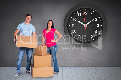 Composite image of young couple with moving boxes