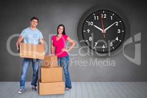 Composite image of young couple with moving boxes