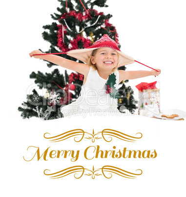 Composite image of festive little girl smiling at camera